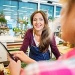 happy florist with customer at counter