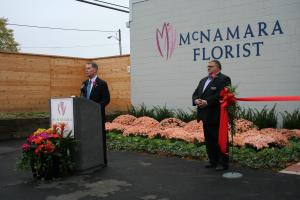 Mayor Joe Hogsett (wearing a rose on his lapel) attended the ribbon cutting ceremony for McNamara Florist’s new headquarters, in a section of Indianapolis that’s being revitalized. Hogsett asked to be included in the event after reading about the extensive renovation process in a local business publication, according to owner Toomie Farris, AAF, AIFD (right).