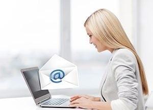 Woman at computer sending email