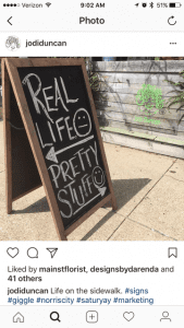 A recent sign outside Jodi Duncan’s Norris City, Illinois shop reminds locals that flowers are a whole lot nicer than the real world.