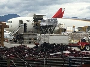 cargo plane on a tarmac being loaded