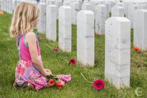 A young girl reflects at Miramar National Cemetery in San Diego. “I honestly don’t ever see myself doing anything on Memorial Day,” said Mike Mooney of Dramm & Echter, who helped organize the event.