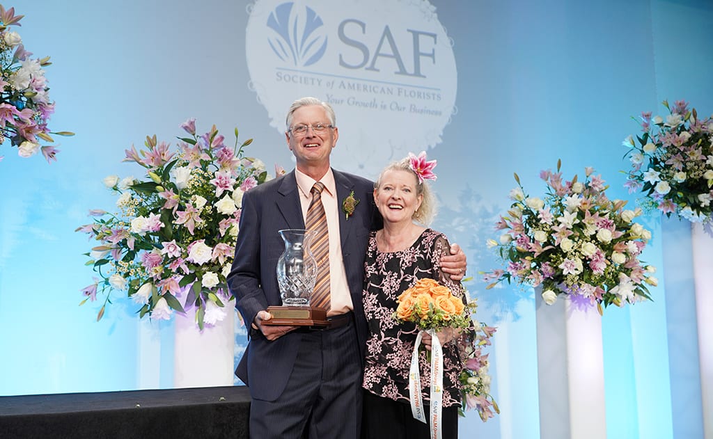 Bobbi Ecker-Blatchford’s children, Bruce and Cyndi, accept her Hall of Fame Award on her behalf during SAF Palm Springs 2018.